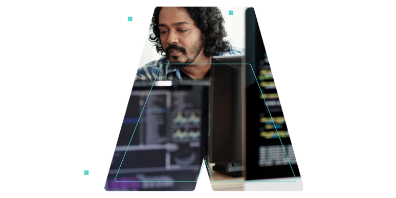 A man behind some computer monitors outlined in the shape of the letter A.