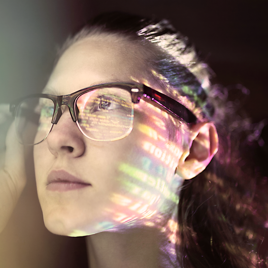 A woman's face masked by expanded T A G 1 characters.